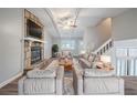 Cozy living room featuring a stone fireplace, high ceilings, and a comfortable seating area for relaxing at 446 Jaywood Dr, Stone Mountain, GA 30083