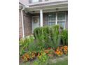 Lush garden featuring colorful blooms surrounds the front door and complements the home's exterior at 167 Diamond Ridge Ave, Canton, GA 30114