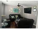 Cozy living room with hardwood floors, ceiling fan, and comfortable leather seating at 1793 Cutters Mill Way, Lithonia, GA 30058