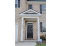 Close-up of the front door with white trim, black door, and 'welcome' sign at 2159 Redfern Rd, Dacula, GA 30019