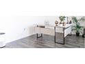 Modern office setup with a sleek desk, minimalist decor, and wood-look floors at 2159 Redfern Rd, Dacula, GA 30019