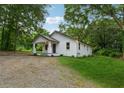Well-maintained home on a spacious lot with mature trees, showcasing the property's outdoor space at 4451 Flat Shoals Pkwy, Decatur, GA 30034