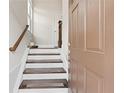 Inviting entryway with hardwood stairs and a view into the home's interior at 4458 Dunblane Ave, Sugar Hill, GA 30518