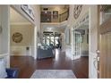 The foyer features gleaming hardwood floors, a soaring ceiling, and an open staircase at 4547 Meadow Green Nw Ln, Acworth, GA 30101