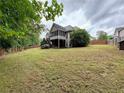 Spacious backyard with mature trees and a screened-in porch, perfect for outdoor living at 237 Shockley Way, Dallas, GA 30157
