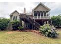 Back exterior with a wooden deck, stairs and a screened-in porch at 237 Shockley Way, Dallas, GA 30157