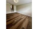 Spacious living room with hardwood flooring, neutral paint, and staircase access at 405 Fairburn Sw Rd # 231, Atlanta, GA 30331