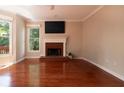 Bright and airy living room with hardwood floors, a fireplace, and large windows for natural light at 5287 Wild Indigo Way, Acworth, GA 30102