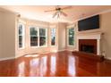 Inviting living room with hardwood floors, a fireplace, and large windows for natural light at 5287 Wild Indigo Way, Acworth, GA 30102