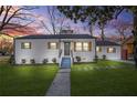 Charming one story home featuring new siding, gray shutters, green grass, and welcoming front porch at 1092 Donnelly Sw Ave, Atlanta, GA 30310