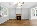 Well-lit living room with a stone fireplace, hardwood floors, and large windows at 1283 Mercer, East Point, GA 30344