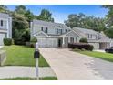 Inviting two-story home featuring a lush green lawn, mature trees, and a long driveway at 1609 Vinery Se Ln, Mableton, GA 30126