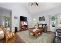 Bright living room featuring a rocking chair, television, and access to other rooms at 325 Harris Loop, Dallas, GA 30157