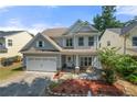Charming two-story home with a manicured lawn, attached garage, and inviting front porch at 1871 Stoney Chase Dr, Lawrenceville, GA 30044