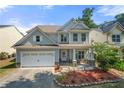 Charming two-story home with a manicured lawn, attached garage, and inviting front porch at 1871 Stoney Chase Dr, Lawrenceville, GA 30044