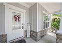 Welcoming front porch with stone accents and seasonal decor, white trim, and wainscoting at 1871 Stoney Chase Dr, Lawrenceville, GA 30044