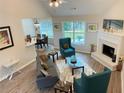 Inviting living room featuring a fireplace, plush seating, and wood floors at 3066 Gem Creek Rd, Buford, GA 30519