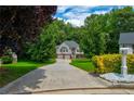 Beautiful two-story home featuring a long driveway with mature trees and landscaping in a lush setting at 40 Legend Creek Chase, Douglasville, GA 30134