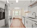 Bright kitchen featuring stainless steel appliances, white cabinets, and a cozy breakfast nook at 2941 Governors Ct, Marietta, GA 30066