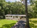 Attractive single story home with a vibrant green lawn, modern accents, and an attached covered carport at 3620 W Lawrenceville St, Duluth, GA 30096