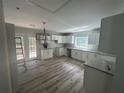 Bright kitchen with white cabinets, granite countertops, wood floors, and stainless steel sink at 4610 Wilson James Sw Rd, Atlanta, GA 30331