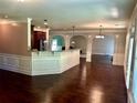 Bright living room featuring hardwood floors, high ceilings, white trim and archways leading to other spaces at 5896 Cliftondale Dr, Atlanta, GA 30349