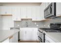 Bright kitchen features stainless steel appliances and stylish backsplash at 1648 Florence Nw Run, Atlanta, GA 30318