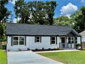 Inviting one-story home showcasing freshly painted brick, professionally landscaped yard, and a charming covered entryway at 1937 Don Juan Ln, Decatur, GA 30032