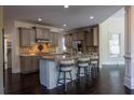 Open kitchen with center island, granite countertops, and stainless steel appliances at 610 Big Bend Trail, Sugar Hill, GA 30518