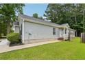 Charming single-story home featuring light gray siding, a well-kept lawn, and a cozy entrance at 1528 Wembley Dr, Douglasville, GA 30134