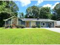 Charming home with stone accents, blooming flowers, and well-maintained lawn creates a welcoming curb appeal at 2913 Jordan Forest Trl, Lawrenceville, GA 30044