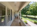 Covered front porch featuring decorative railings and a view of the landscaped yard at 334 Bridgewood Se Dr, Conyers, GA 30094
