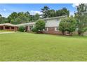 Charming home with a well-manicured lawn, complemented by a brick and siding exterior at 5440 Huron Dr, Lake City, GA 30260