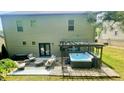 Backyard view featuring a jacuzzi, pergola, and outdoor seating area at 109 Red Fox Dr, Dallas, GA 30157