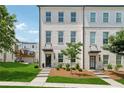 Charming three-story townhome with painted brick and manicured front yard at 3440 Hardy St, Duluth, GA 30096