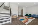 Inviting living room features staircase, recessed lights and rainbow rug at 3440 Hardy St, Duluth, GA 30096