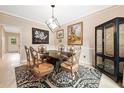 Elegant dining room with decorative chairs, marble table, and a contemporary light fixture at 4771 Summerwood Se Dr, Smyrna, GA 30126