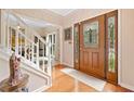 Inviting foyer with hardwood floors, a decorative front door with sidelights, and a staircase with white railings at 4771 Summerwood Se Dr, Smyrna, GA 30126