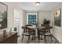 Charming dining area with a round table, comfortable chairs, and a window view at 58 Monet Nw Ct, Atlanta, GA 30327