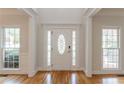 Bright foyer with hardwood floors, a decorative front door, and large windows at 1172 Oakhurst Trl, Lawrenceville, GA 30043