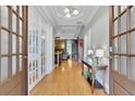 Inviting foyer with hardwood floors, tray ceilings, and glass-paneled doors opening to other rooms at 130 Holly Reserve Pkwy, Canton, GA 30114