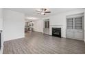 Bright living room featuring gray wood floors, fireplace, built-in cabinets, and an open concept at 377 Danville Ave, Suwanee, GA 30024