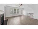 Spacious living room with wood floors, large windows, and adjacent access to the outdoor area at 377 Danville Ave, Suwanee, GA 30024