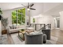 Bright living room with soaring ceilings and large windows with a view of the surrounding forest at 515 Dover St, Marietta, GA 30066