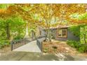 Charming home featuring a ramp walkway, mature trees, and lush landscaping creates a private setting at 5848 Kingswood Ct, Norcross, GA 30093