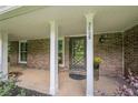 Charming front porch with brick accents and decorative floral arrangements by the door at 5868 Kingswood Nw Ct, Norcross, GA 30093
