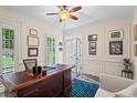 Bright home office featuring plantation shutters, crown molding, and wainscoting at 121 Clipper Bay Drive, Alpharetta, GA 30005