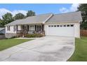 Ranch-style home showcasing a spacious driveway leading to a two-car garage and front porch at 1250 Timber Walk Dr, Loganville, GA 30052