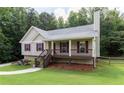 Charming single-story home with a well-maintained lawn, inviting porch, and colorful landscaping at 19 Autumn Ne Pl, White, GA 30184