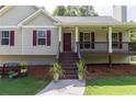 Inviting front porch with classic railings, colorful shutters, and a well-manicured lawn at 19 Autumn Ne Pl, White, GA 30184